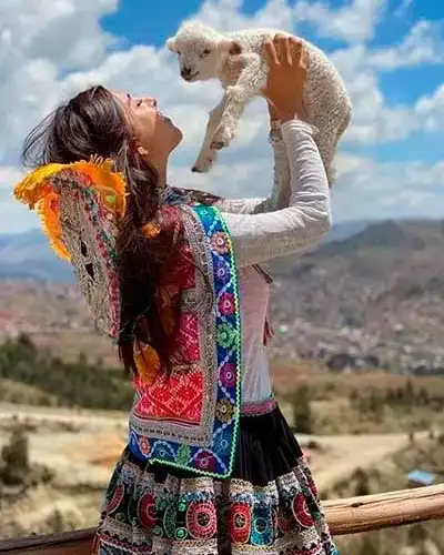 Beautiful Girl Carrying a Sheep in the Sacred Valley